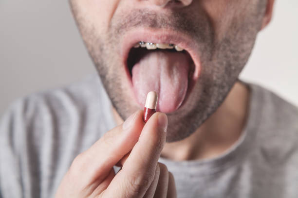 istock Closeup of a man taking pill. 1213425739