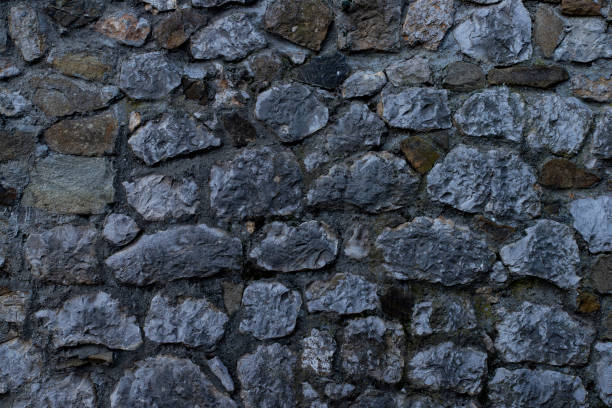 istock Texture of stone wall made of grey stones 1213426824