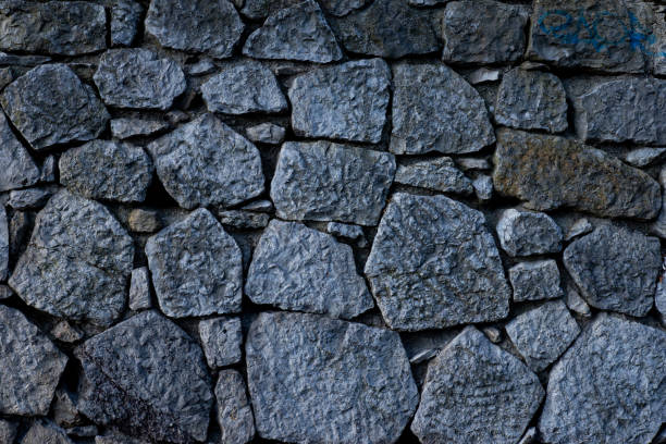 istock Texture of stone wall made of grey stones 1213426829