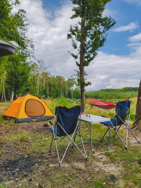 istock camp at forest hammock with tent and portable chairs copy space 1213428608