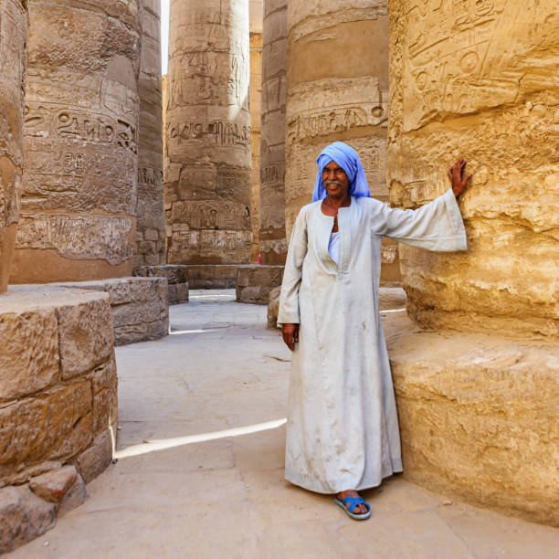 Egyptian man in ancient temple, Egypt Egyptian old man in ancient temple, Egypt temple of luxor hypostyle hall stock pictures, royalty-free photos & images