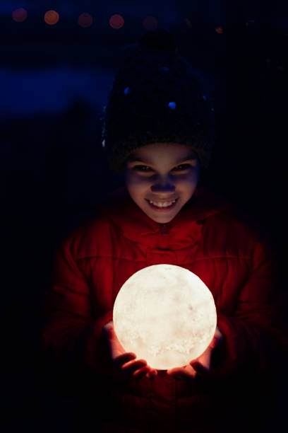 teenager girl in cap and jacket holds a full moon - 5934 imagens e fotografias de stock