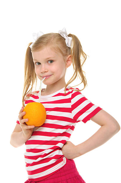 garota beber suco de laranja com palha - isolated on white fun orange food - fotografias e filmes do acervo