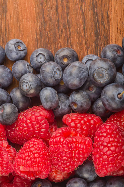istock ripe blueberry and raspberry strips on wood background 1213430418