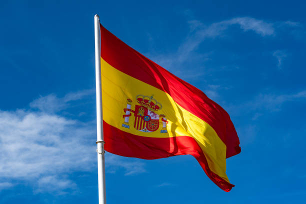 istock Flag of Spain over blue sky background 1213430464