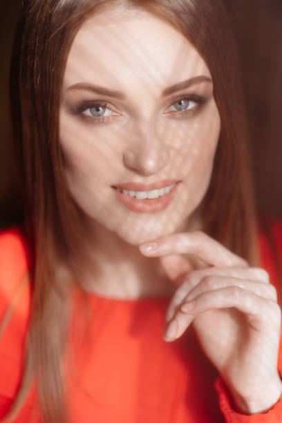 istock shadows on face beautiful girl  in red close-up 1213431690