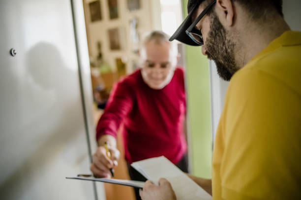 istock The postman brings the post to an older man 1213432732