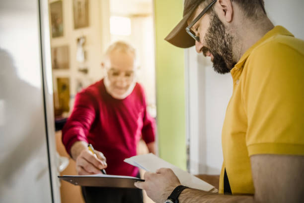 istock The postman brings the post to an older man 1213432747