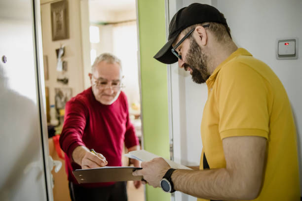 The postman brings the post to an older man