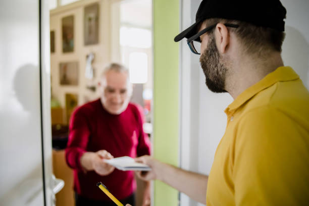 istock The postman brings the post to an older man 1213432790