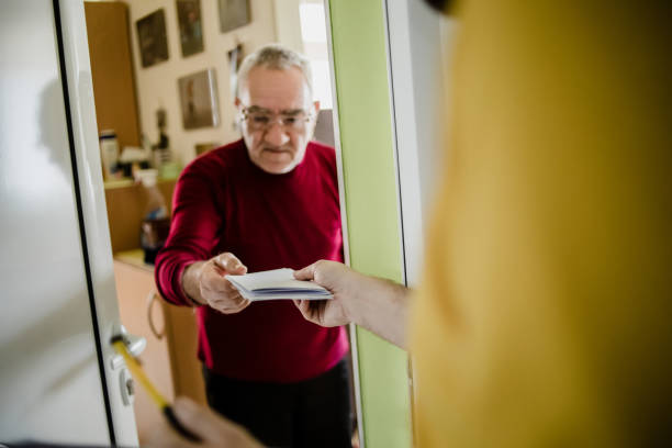 istock The postman brings the post to an older man 1213432827