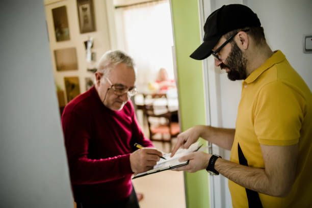 istock The postman brings the post to an older man 1213433003