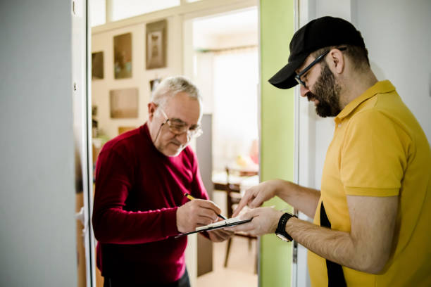 istock The postman brings the post to an older man 1213433019