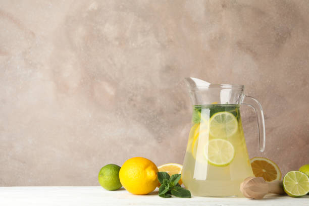 istock Jug with lemonade and ingredients on wooden table. Fresh drink 1213433713