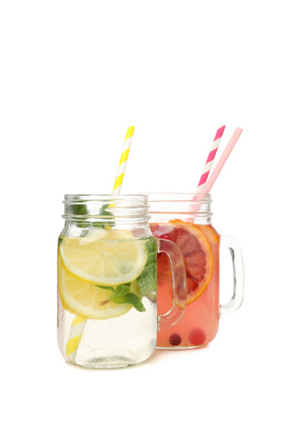 istock Glass jars of lemonade isolated on white background 1213434717