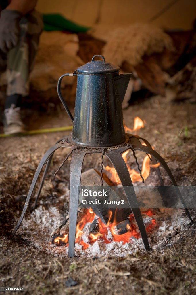 https://media.istockphoto.com/id/1213435432/photo/old-metal-coffee-pot-stands-over-a-campfire.jpg?s=1024x1024&w=is&k=20&c=aq9y8SEDXQNaaAHwFB469TcjkoBfebWK4bfR01gH0nE=