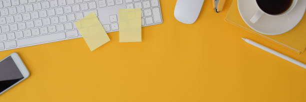 istock Cropped shot of computer device on yellow background 1213436594