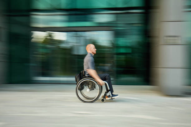 istock Portrait of Businessman with Disability Wheeling to Work 1213437385