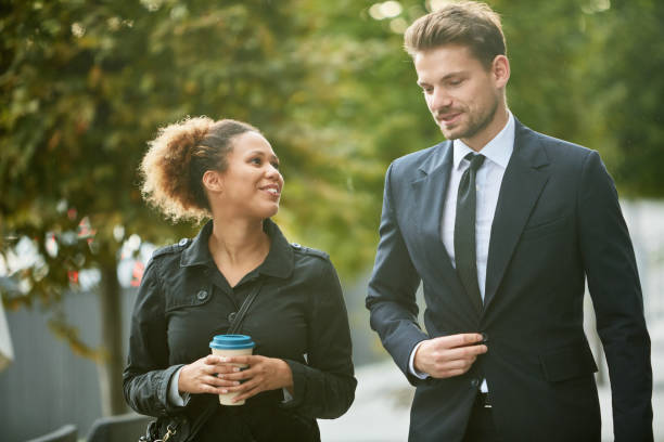istock Friendly Businesspeople Conversing on Their Way to Work 1213437438