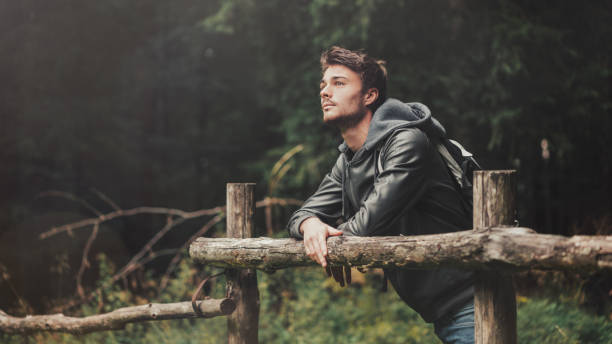 istock Young man hiking in the forest 1213438029