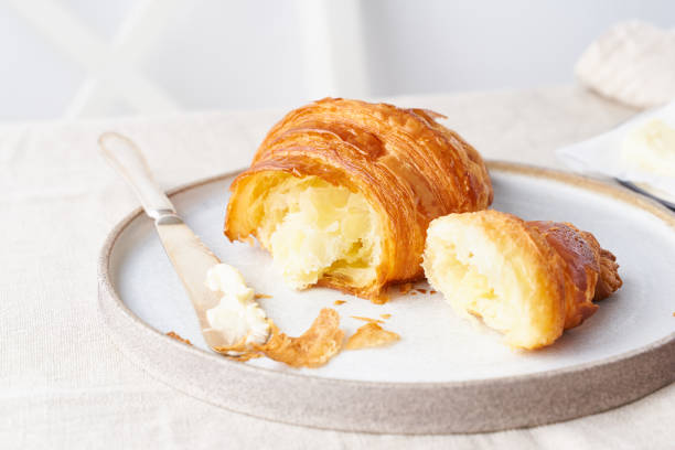 istock Coffee with croissant. Bright sunny morning, leisurely breakfast with fresh pastries, side view 1213438689
