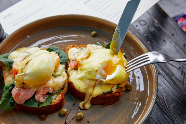 istock two sandwiches with a basil egg and ham, with spices and herbs, which are cut with a knife and a fork 1213438921
