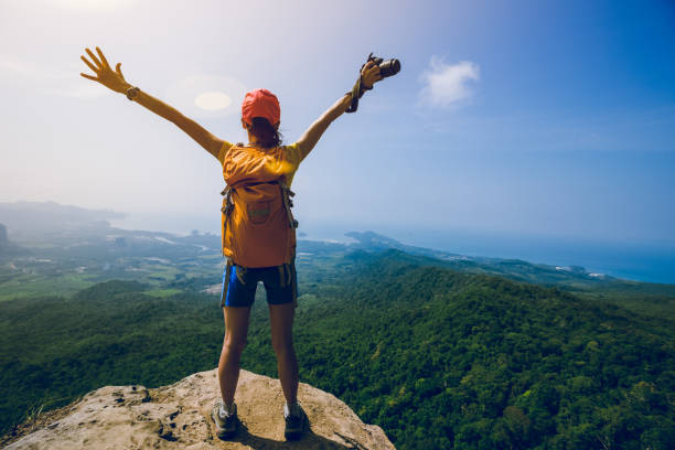 istock Successful woman outstretched arms on mountian top 1213440519