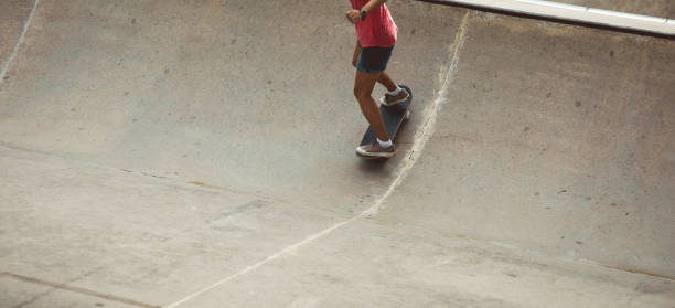 istock Female skateboarder skateboarding at skatepark 1213440977