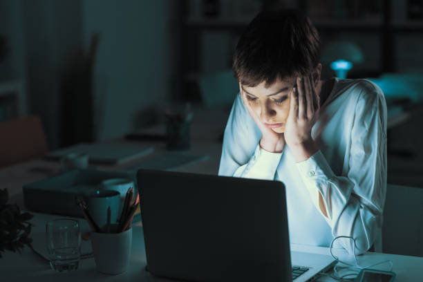 istock Tired woman working late at night 1213449250