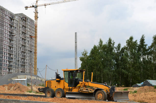 istock Construction machine Motor Grader at a construction site level the ground and gravel stones for the construction of a new asphalt road 1213450724