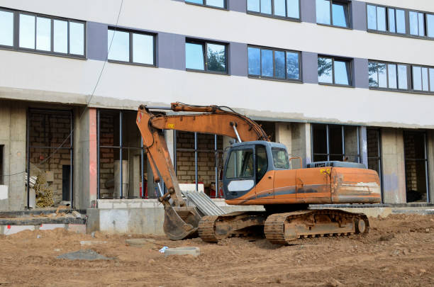 istock Bucked wheel excavator digs ground at a construction site for installing concrete storm pipes. Backhoe the digging pipeline ditch. Commercial and Public Civil Work Contracting, trenching, tamps soil 1213450998