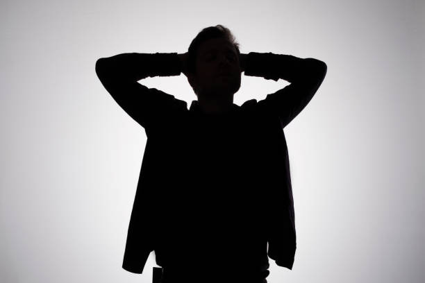 istock Man silhouette on gray studio wall. Anonym concept 1213452065