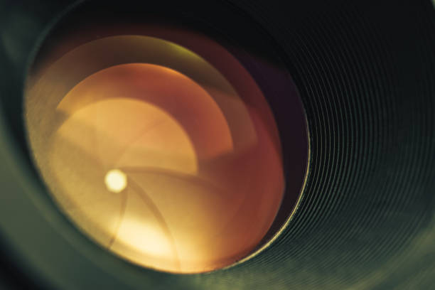 istock Beautiful camera lens with orange  light of glass. Background pattern for design. 1213452174