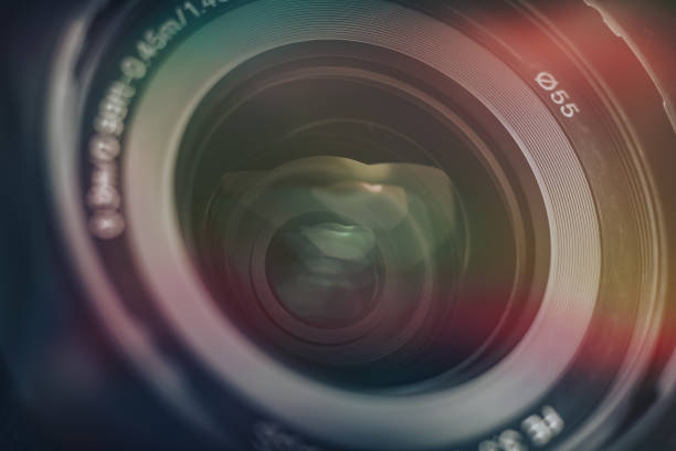 istock Beautiful camera lens with multi colored light of glass. Background pattern for design. 1213452292