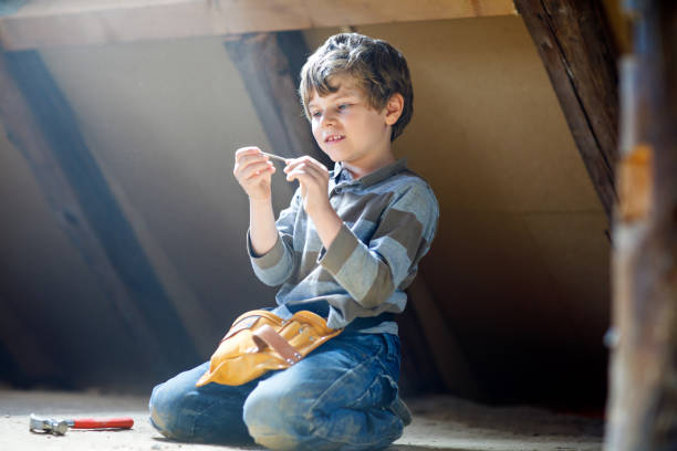 istock Little kid boy helping with toy tools on construciton site. 1213452350
