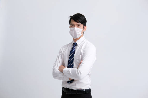 istock businessman man wearing protective mask against cold flu virus bacteria infection pollution 1213452636
