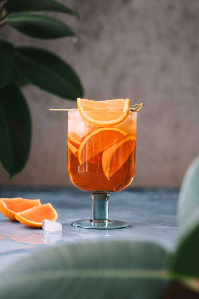 Spritz cocktail with oranges and ice in wine glass