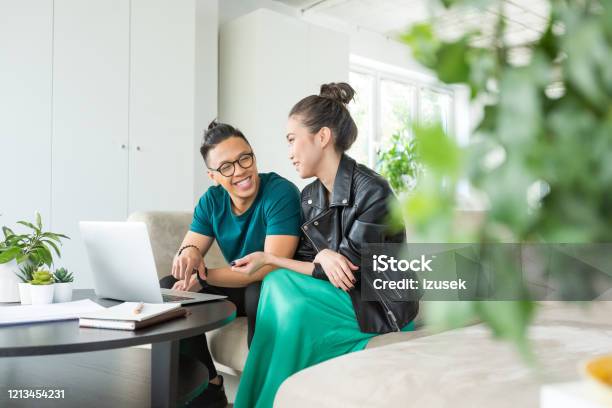 Colleagues Working Together On Laptop In The Office Stock Photo - Download Image Now