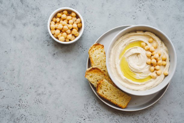 istock Hummus plate with olive oil and chickpeas. Gray background. Copy space 1213455851