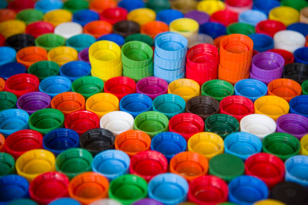 istock Plastic bottle caps background. Cap material is recyclable.Remove lids from plastic bottles before recycling them. Recycling collection and processing plastic bottle caps 1213457659