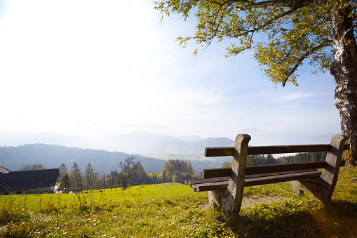 beautiful mountain landscape. mountains in the morning light and a bench in the foreground. Austria\