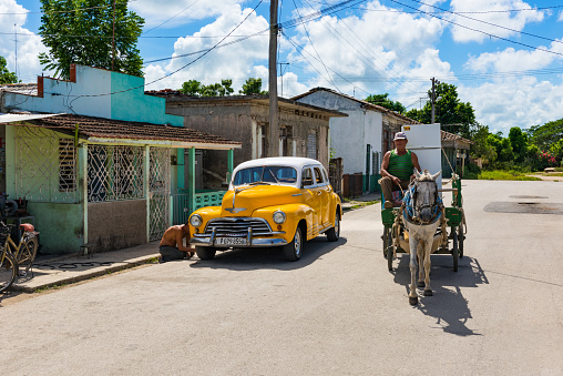 Sagua la Grande, Cuba - September 25, 2018: American yellow 1946 Chevrolet Fleetmaster vintage car with white roof parked on the side street in Sagua la Grande Cuba - Serie Cuba Reportage