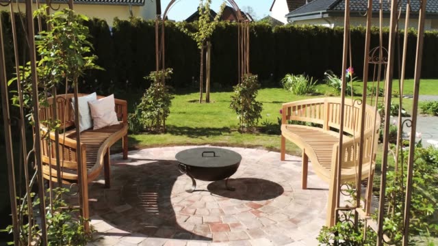 Fantastically beautiful garden with fire pit and rose arches
