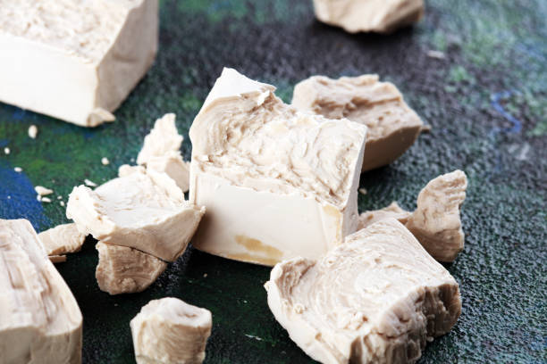 istock Dry yeast crumbled and yeast block for baking on background 1213461159