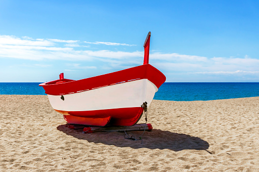 Colourful traditional fishing boat on a Spanish beach.