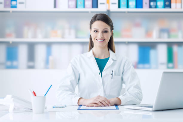 istock Female doctor working at office desk 1213462618