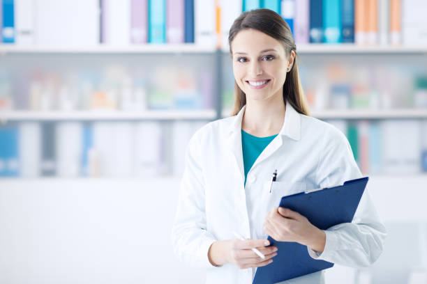 istock Smiling female doctor holding a clipboard 1213462660