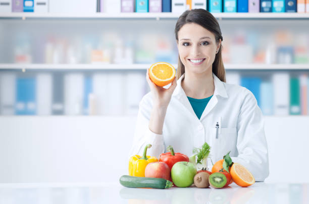 istock Nutritionist holding a sliced orange 1213462984