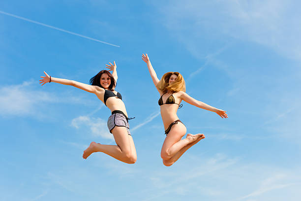 istock Two happy women jumping high with fun 121346399