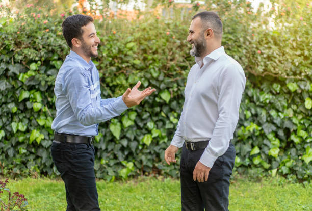 istock Two businessmen discussing about work in outdoors in front of office 1213465008